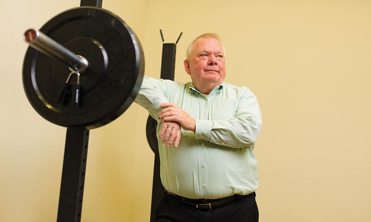 Terry Dibble leaning against weight